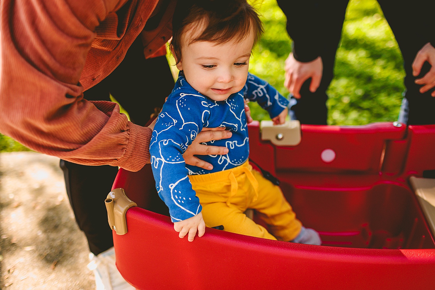 Baby in little red wagon