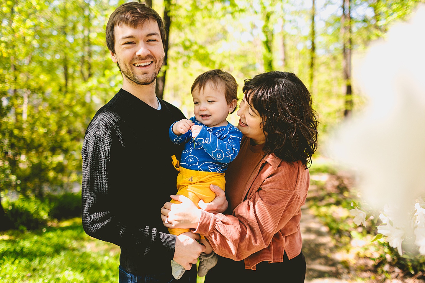 Parents holding laughing baby