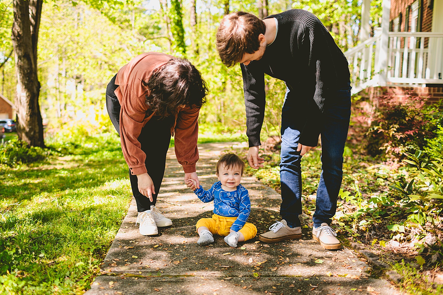 Smiling baby sitting on sidewalk