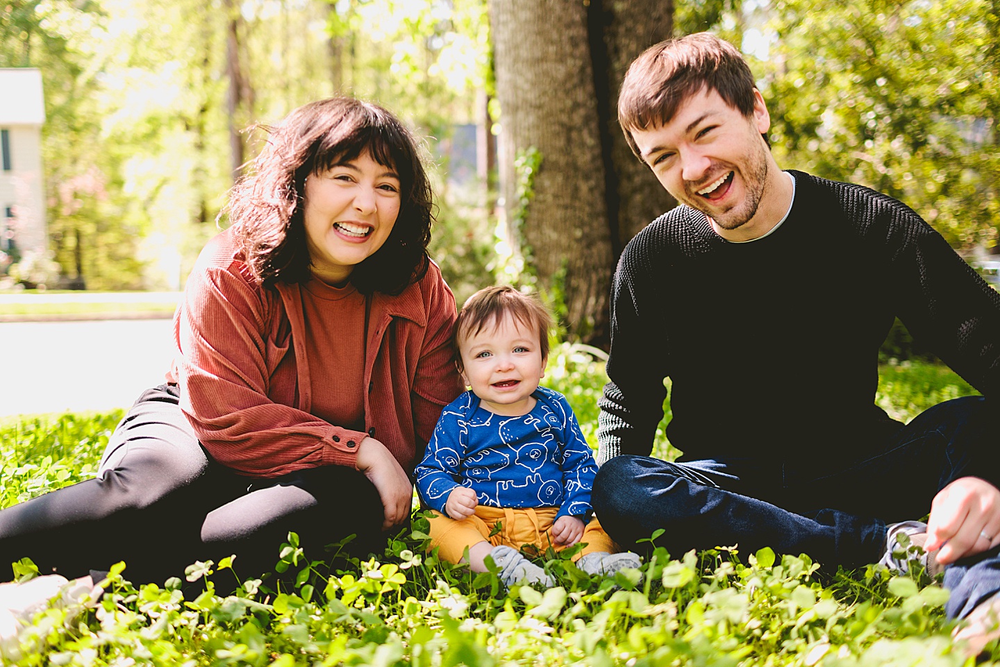 Smiling baby sitting with his parents