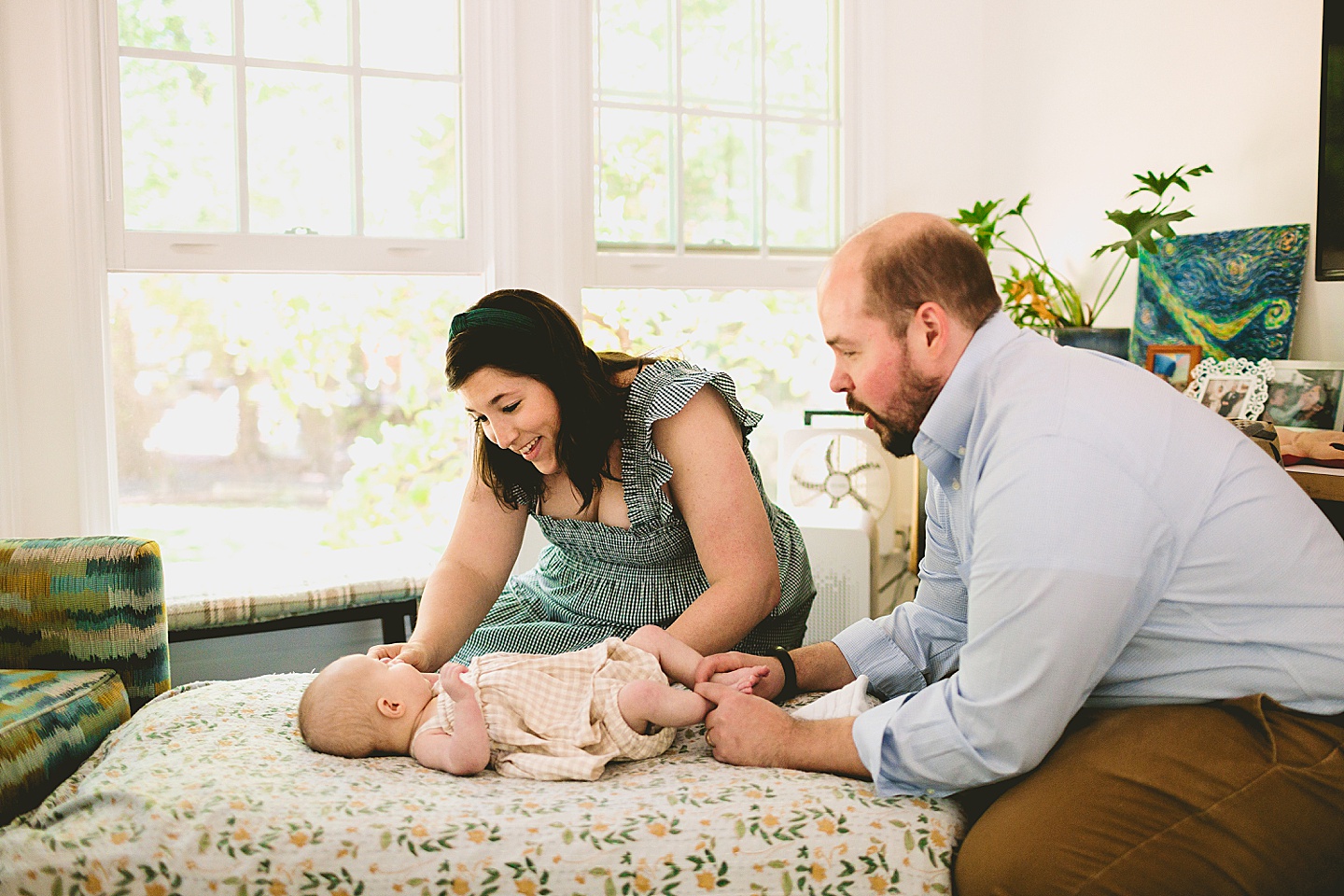 Parents looking and smiling at a baby