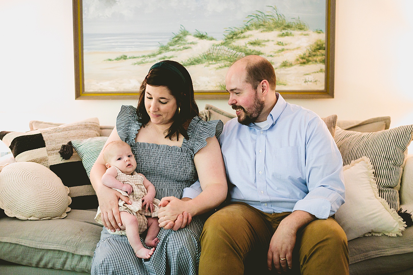 Parents smiling with newborn baby