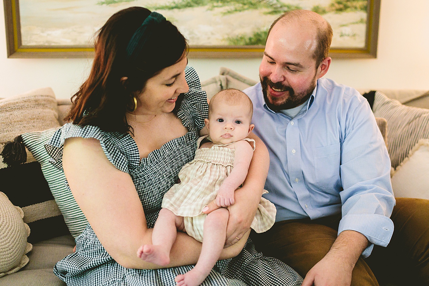 Parents smiling and holding baby