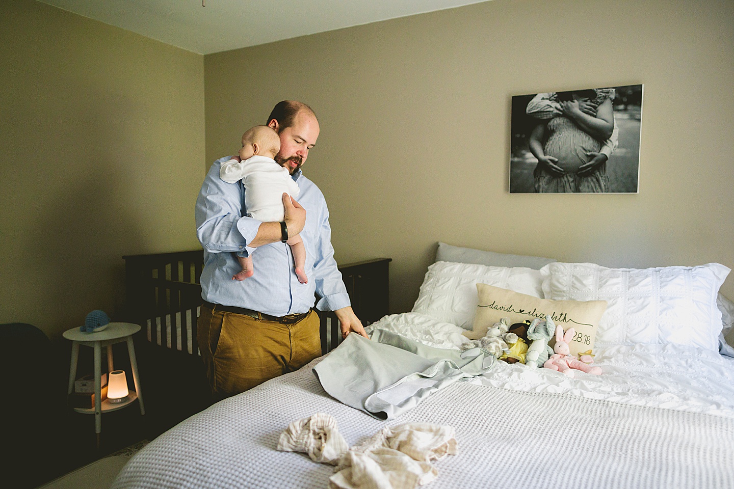 Dad bringing baby into the nursery