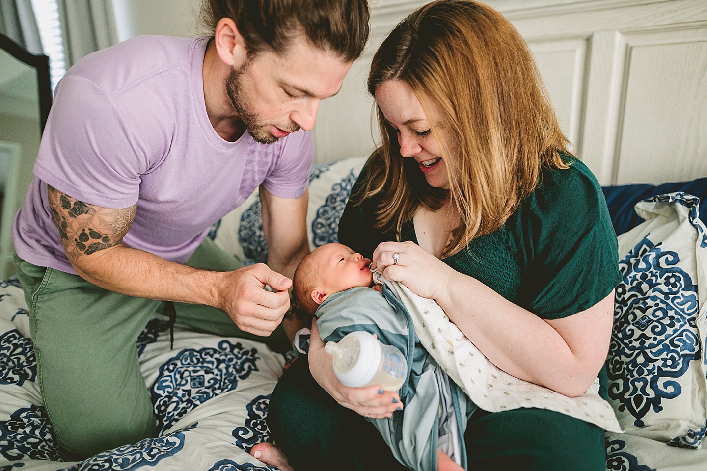 Parents tending to newborn baby