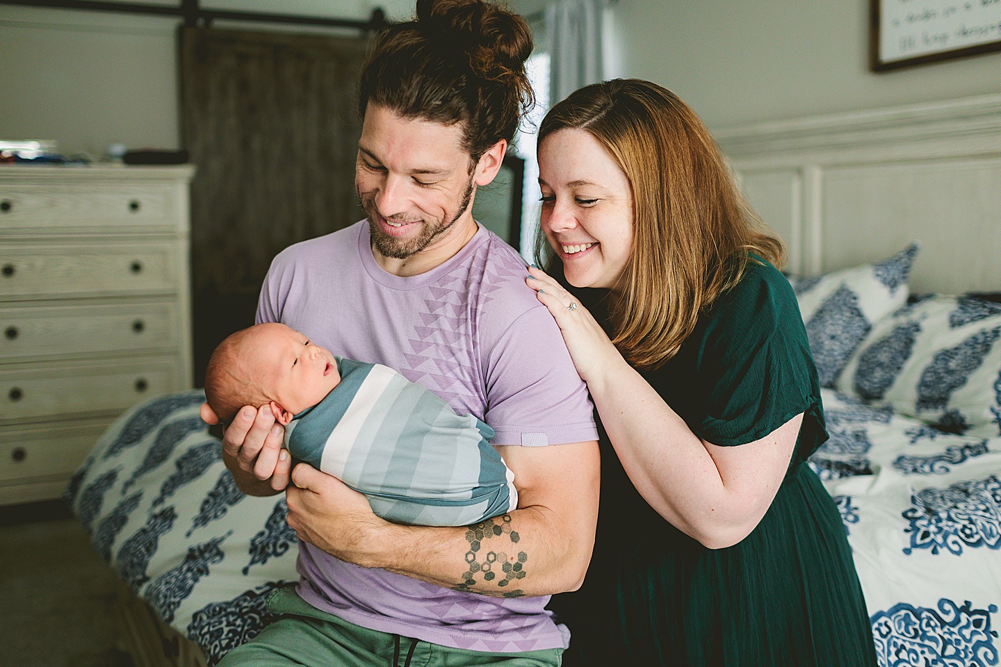 Parents admiring their newborn baby in Raleigh NC family portraits