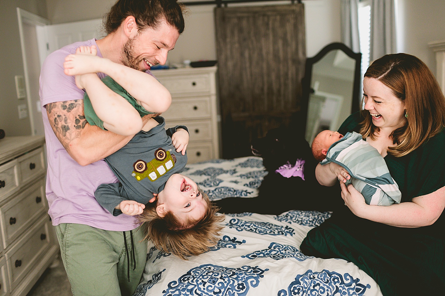 Toddler being held upside down and laughing