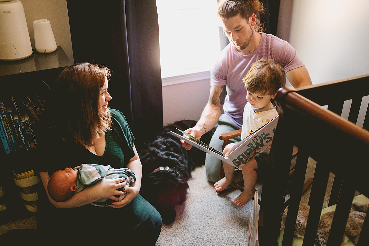 Parents reading to toddler in his room