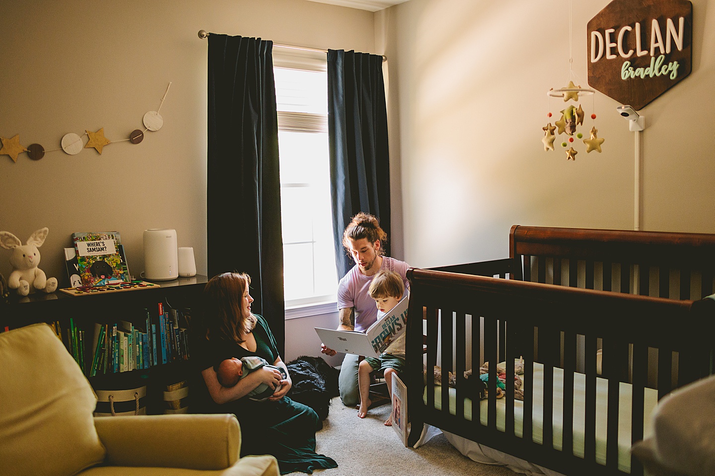 Parents reading to toddler in his room