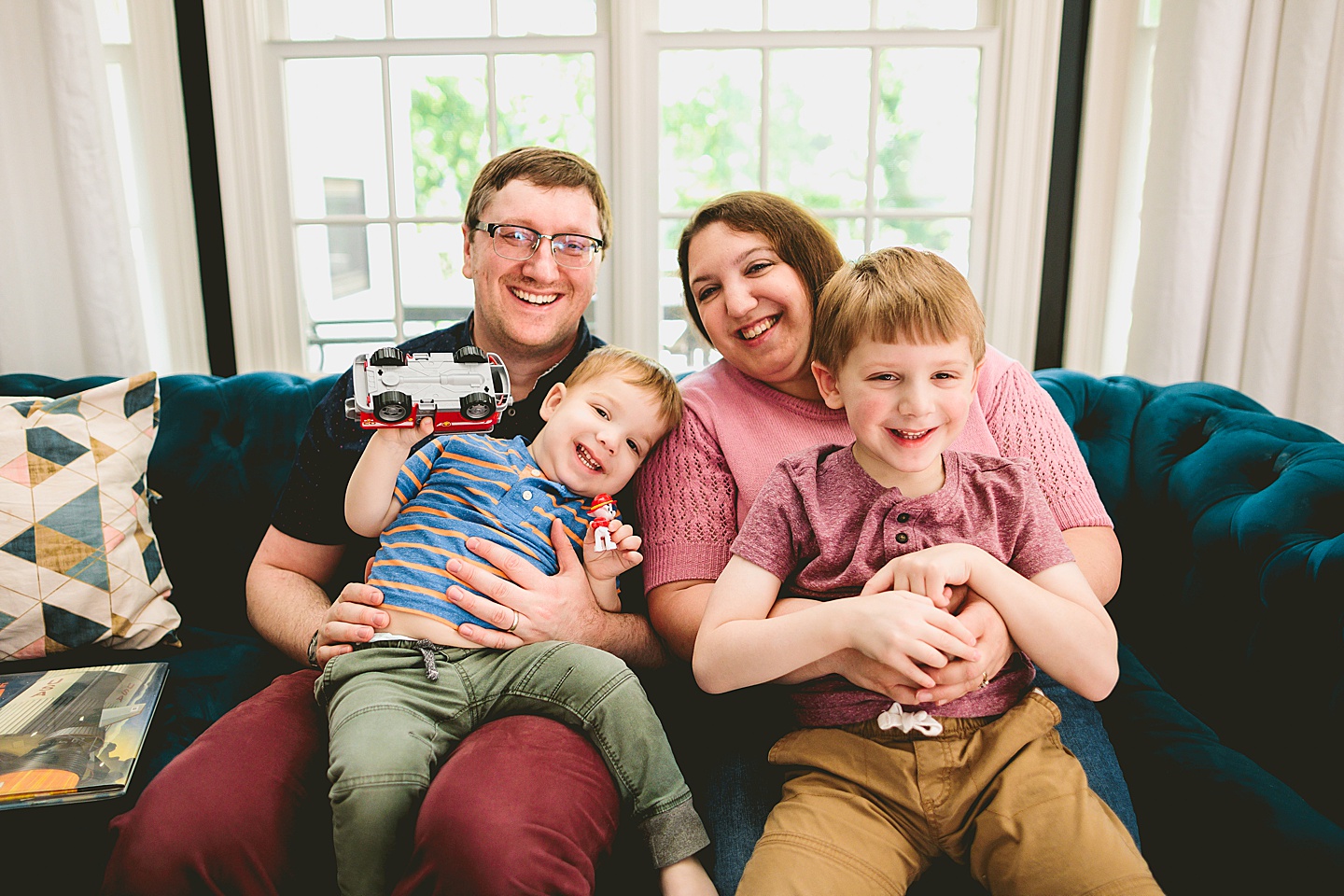 Family portrait smiling together on couch