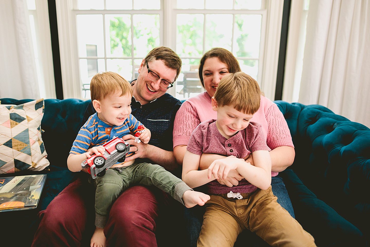 Family portrait smiling together on couch