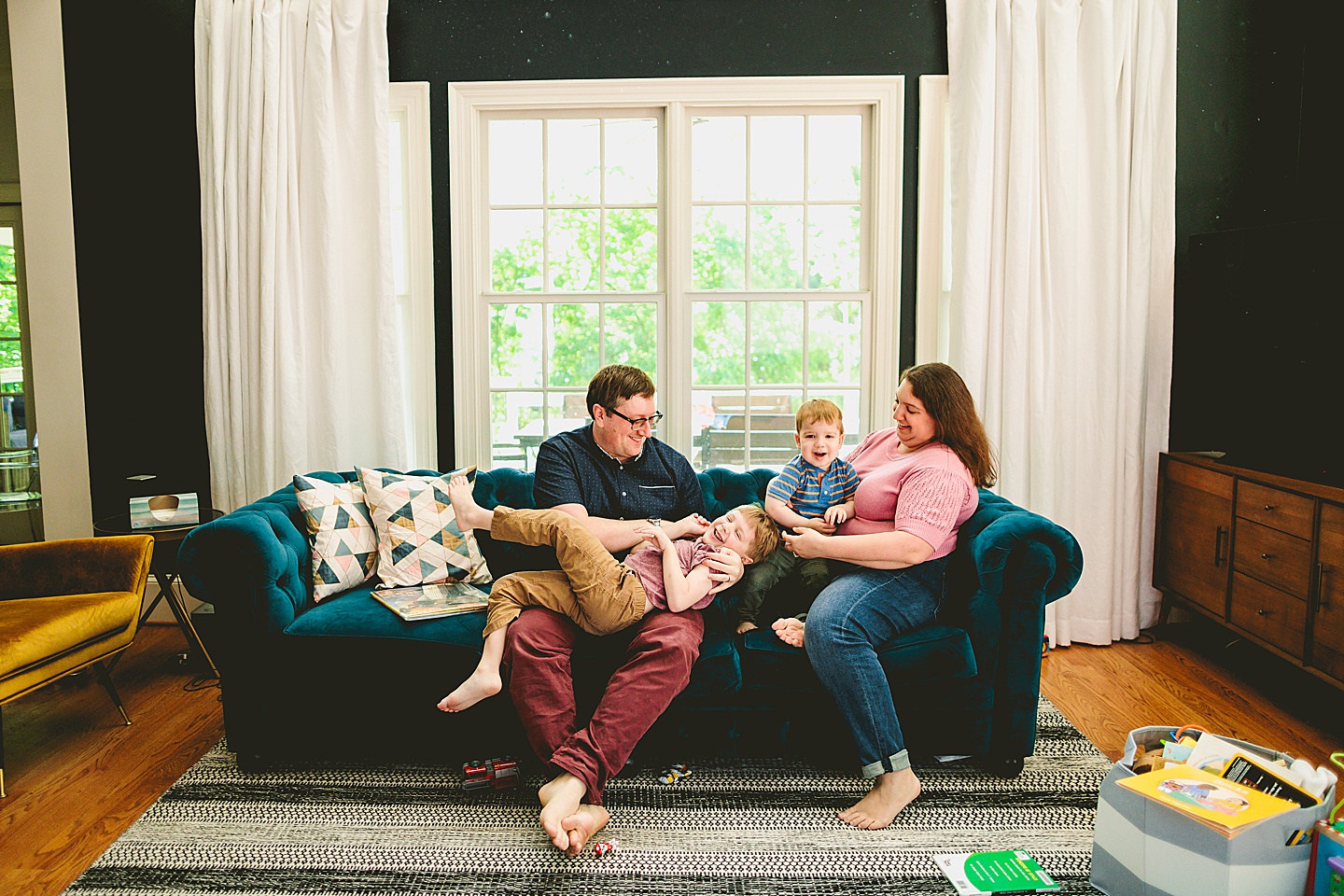 Parents playing with kids on the couch