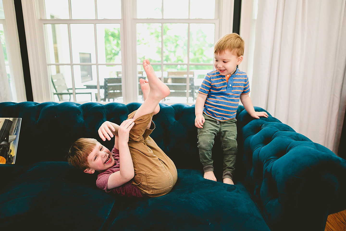 Brothers playing on the couch