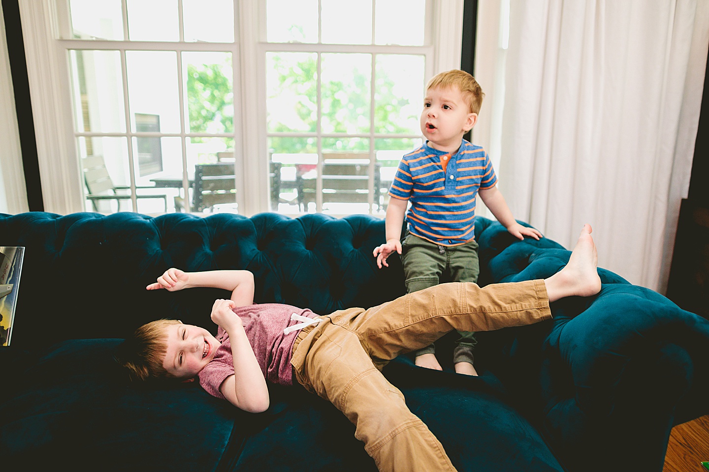 Brothers playing on the couch