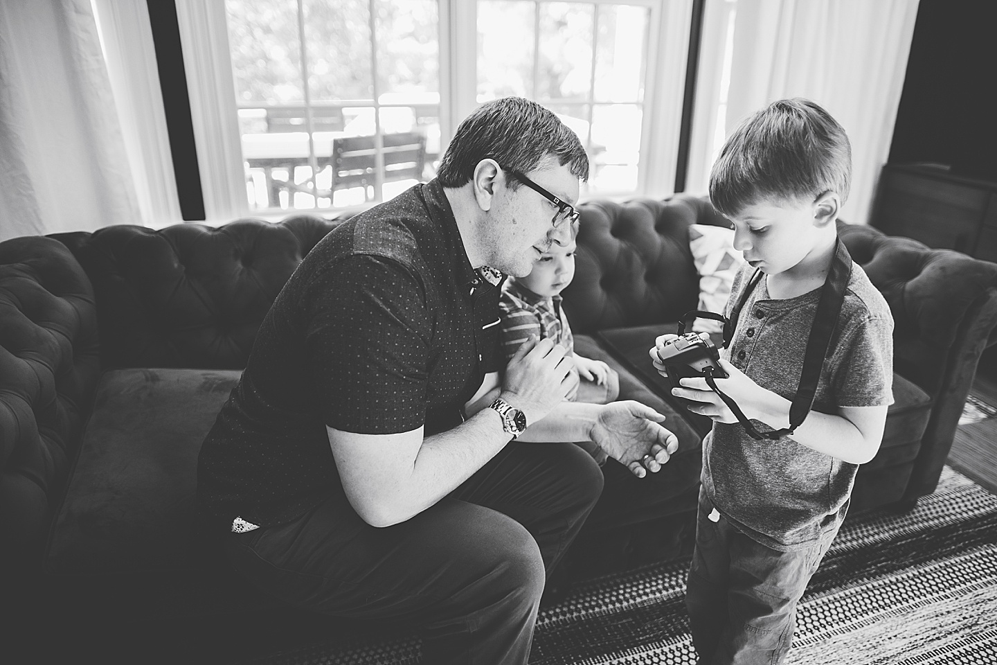 Dad showing son how to work a camera