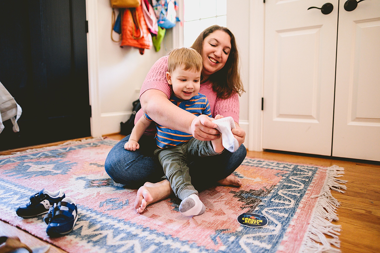 Mom helping son put on socks