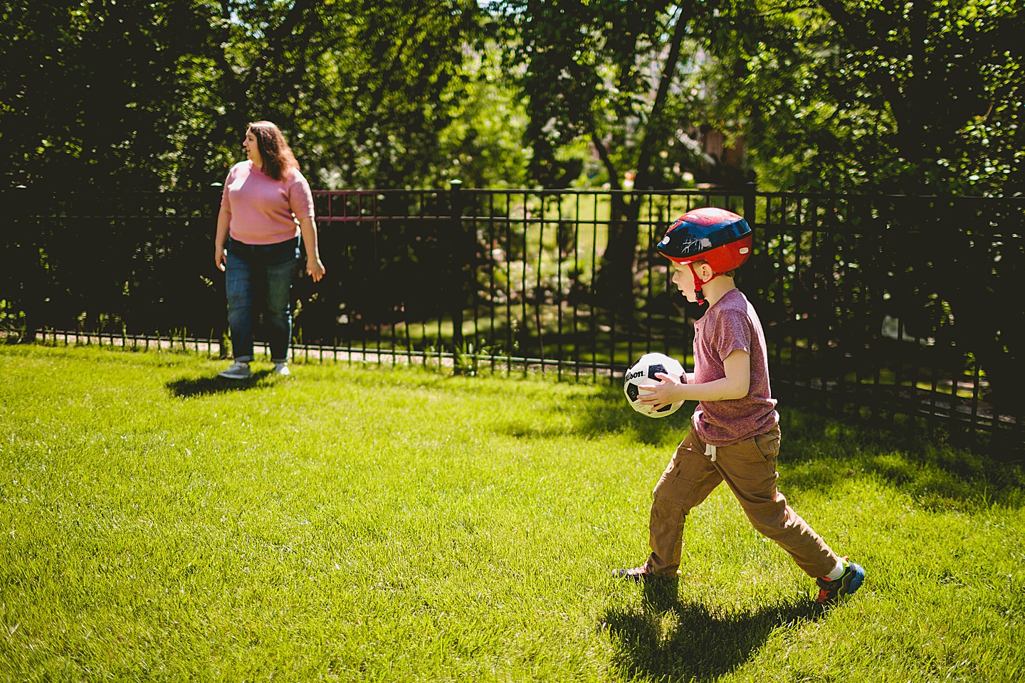 Kid playing soccer while wearing a helmet