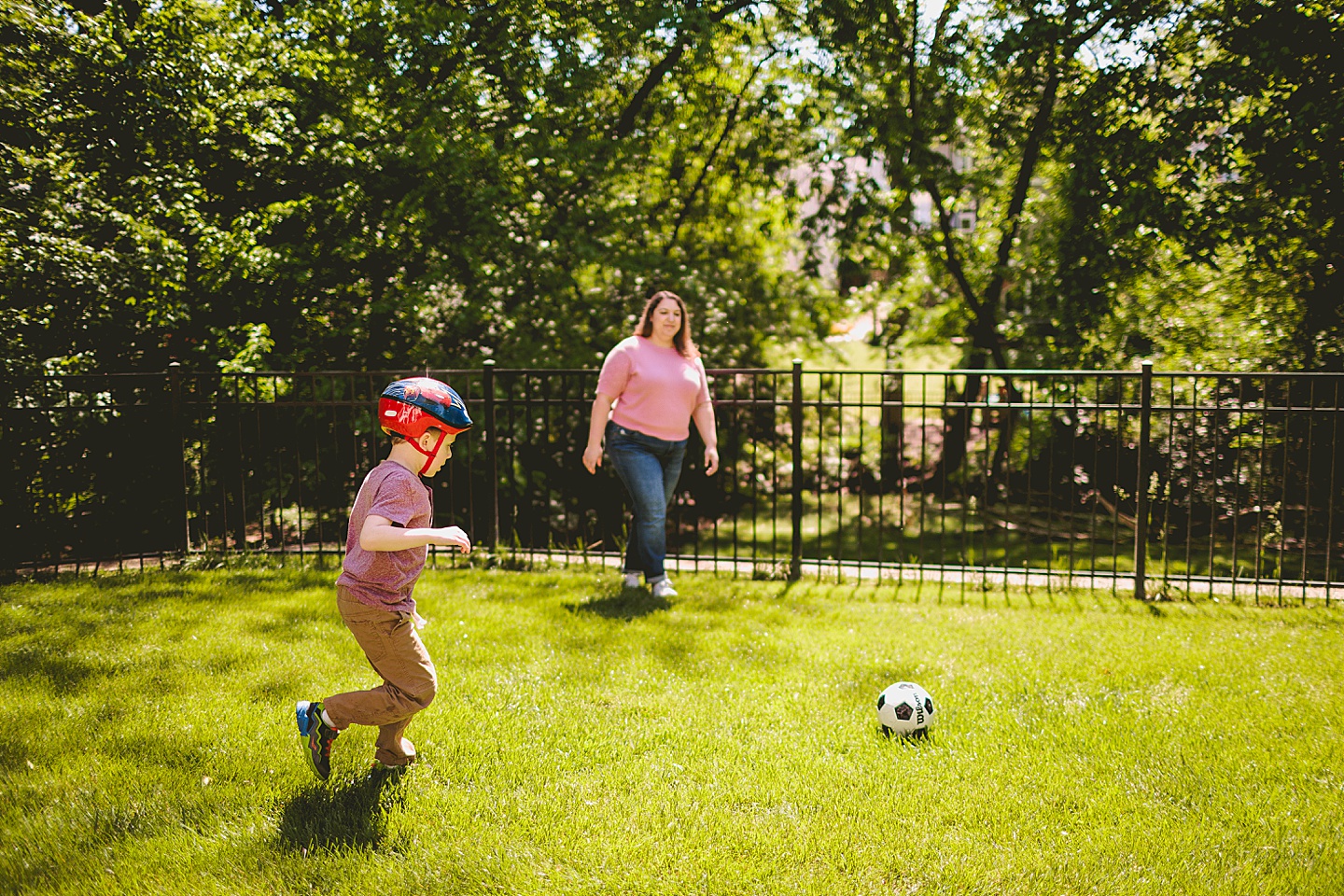 Kid playing soccer while wearing a helmet