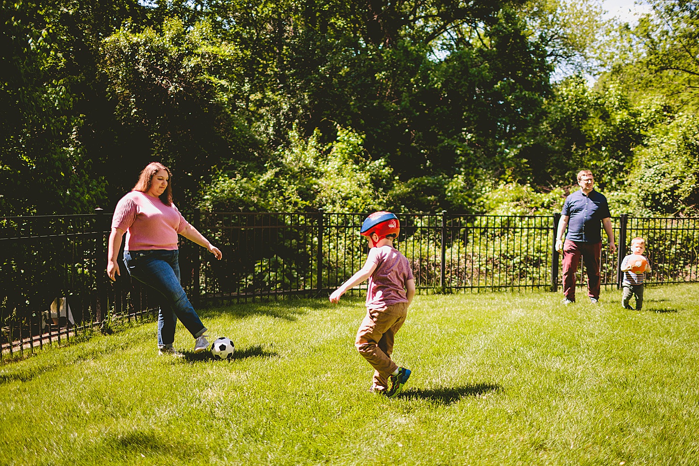 Kid playing soccer while wearing a helmet