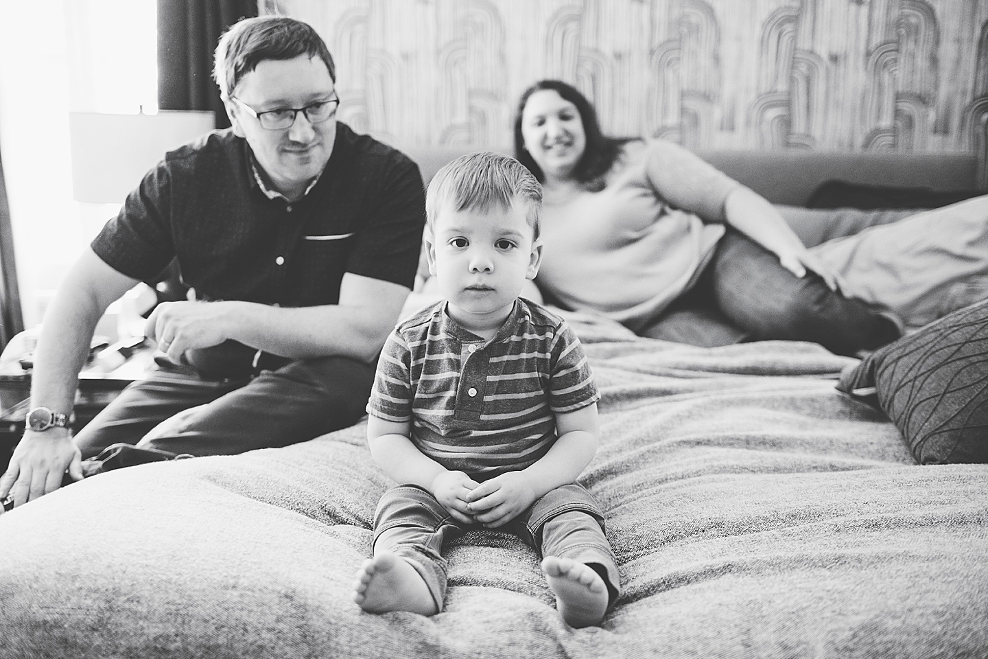 Boy sitting on bed at parents house