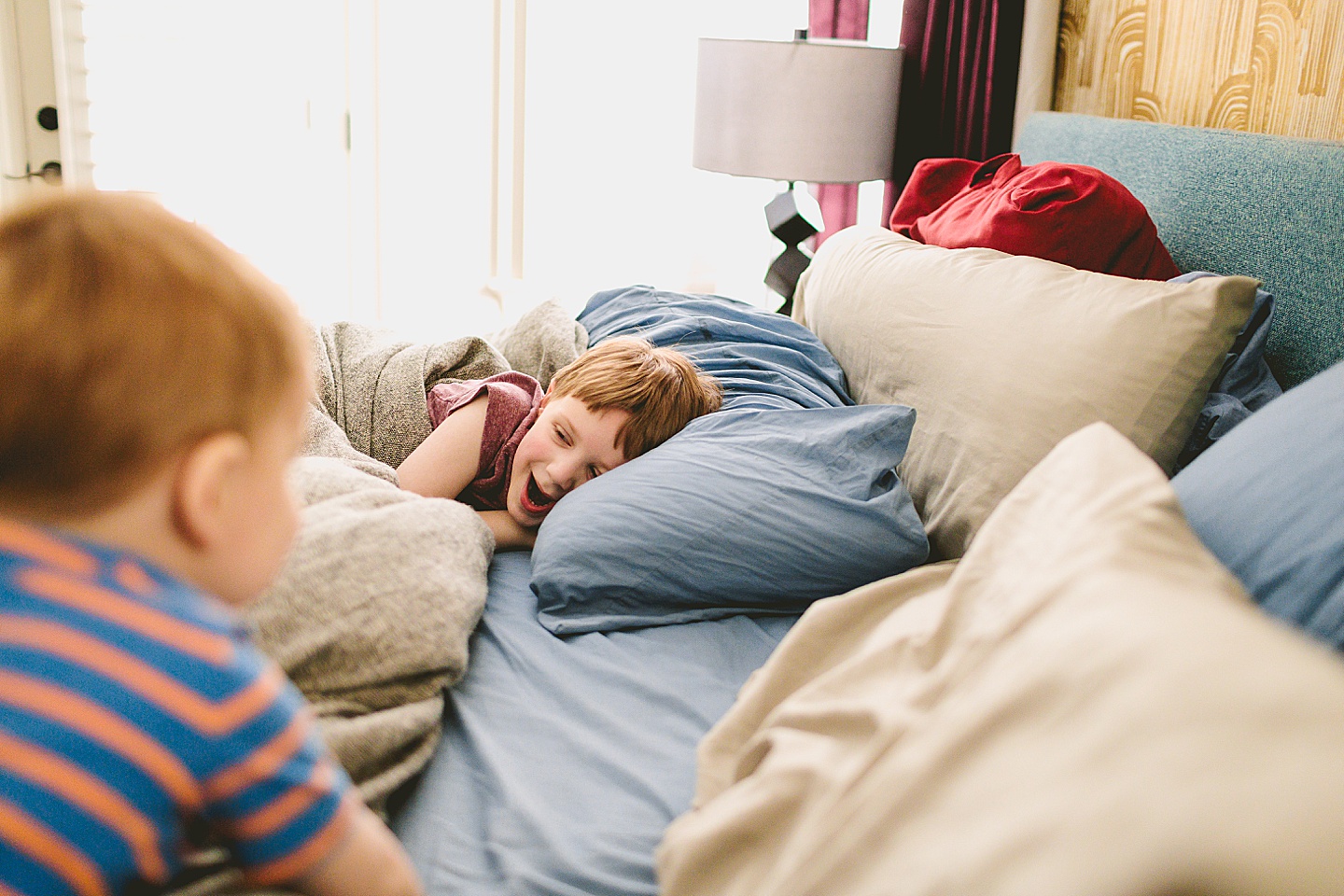 Kids playing on parents' bed