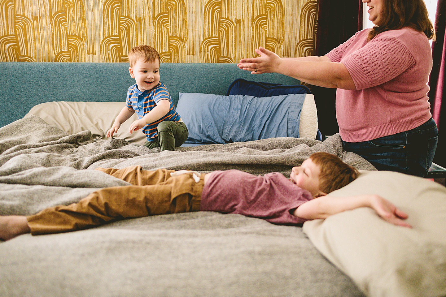 Kid playing on bed during family pictures