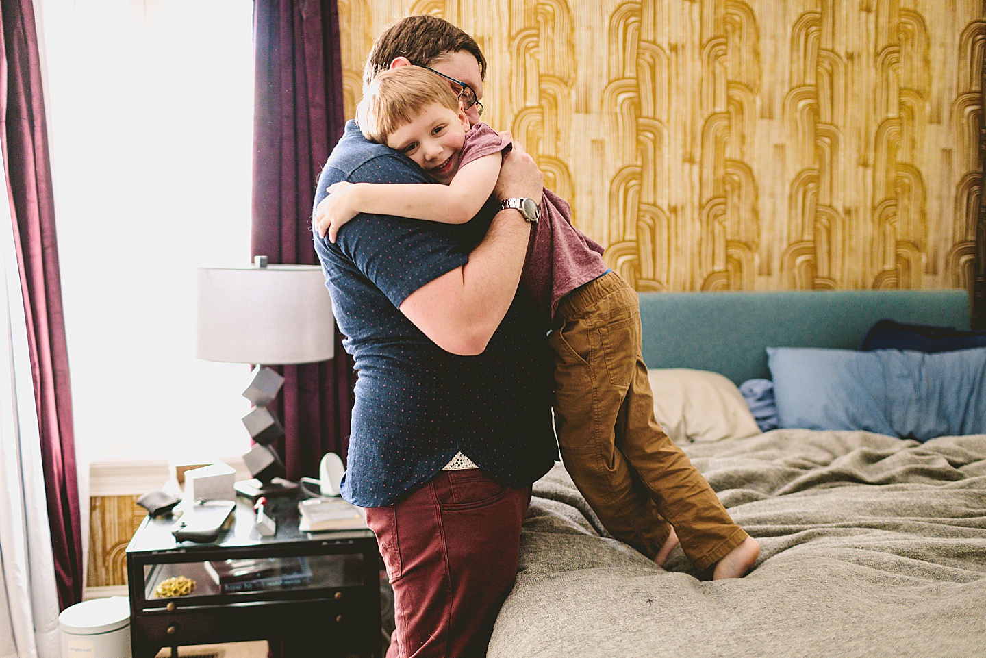 Kid playing on bed during family pictures