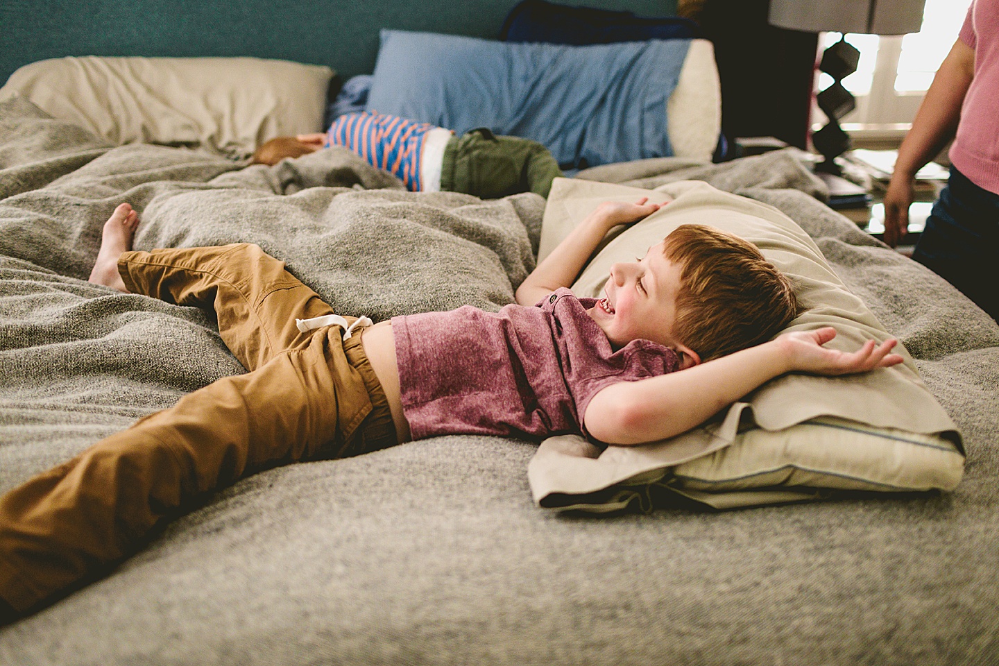 Kid playing on bed during family pictures