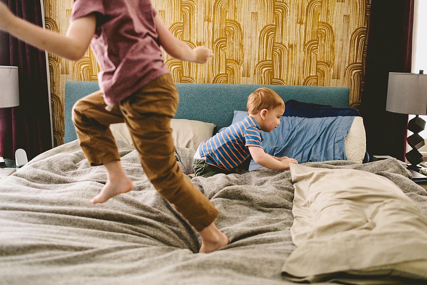 Kid playing on bed during family pictures