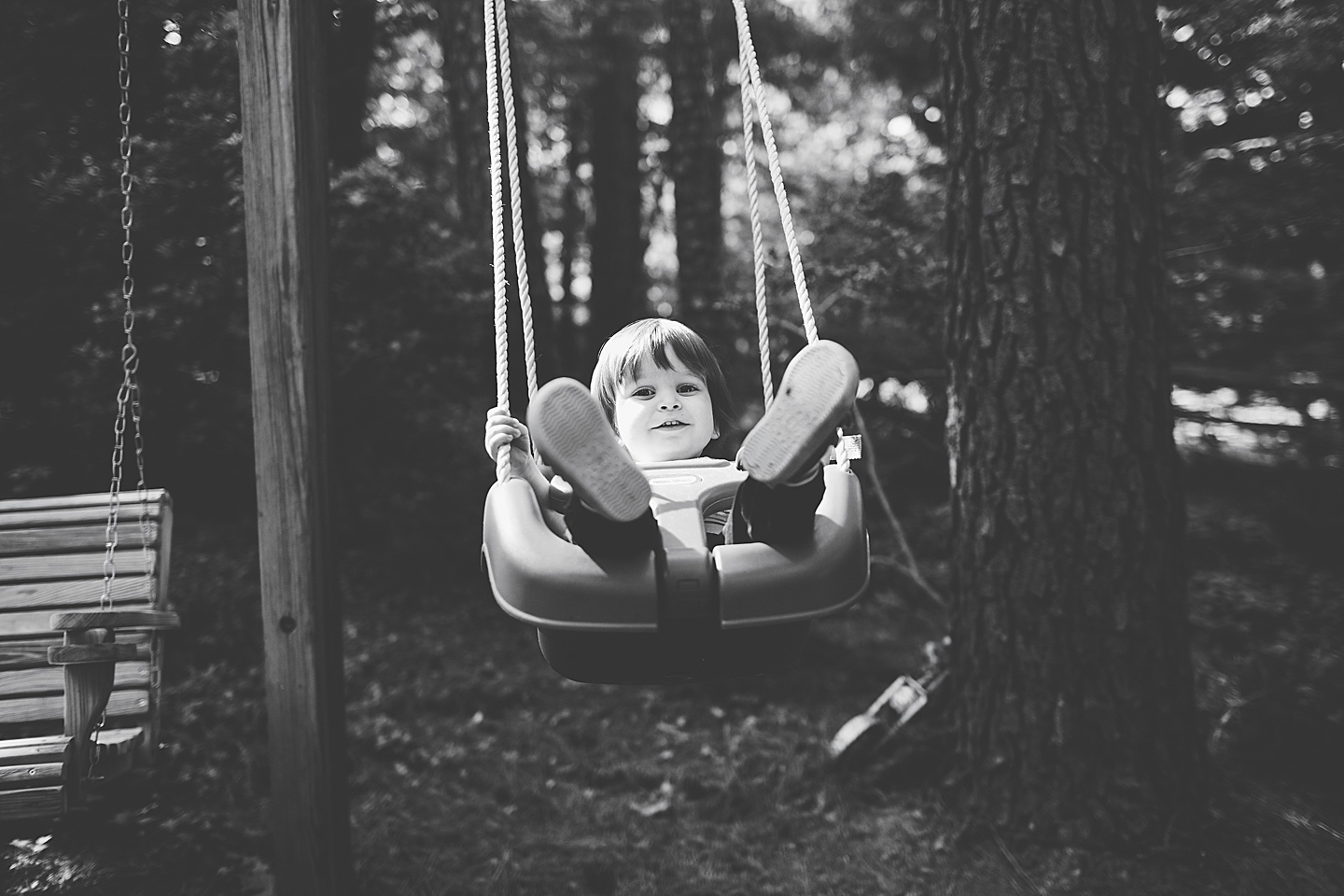 Toddler swinging on swing