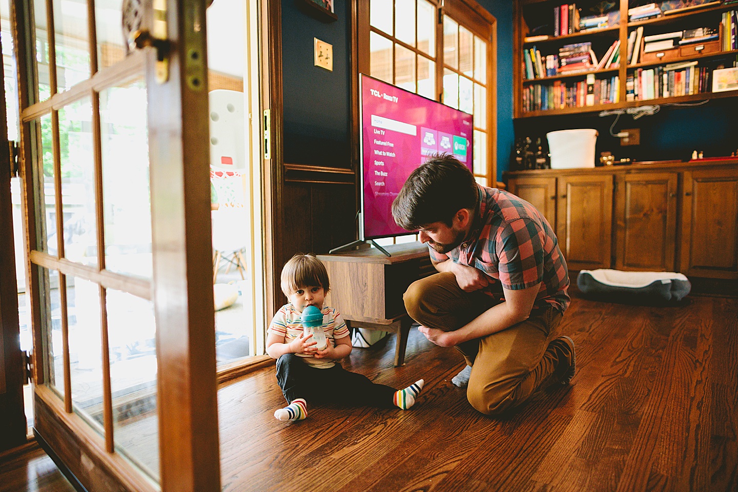 Toddler drinking milk on the floor