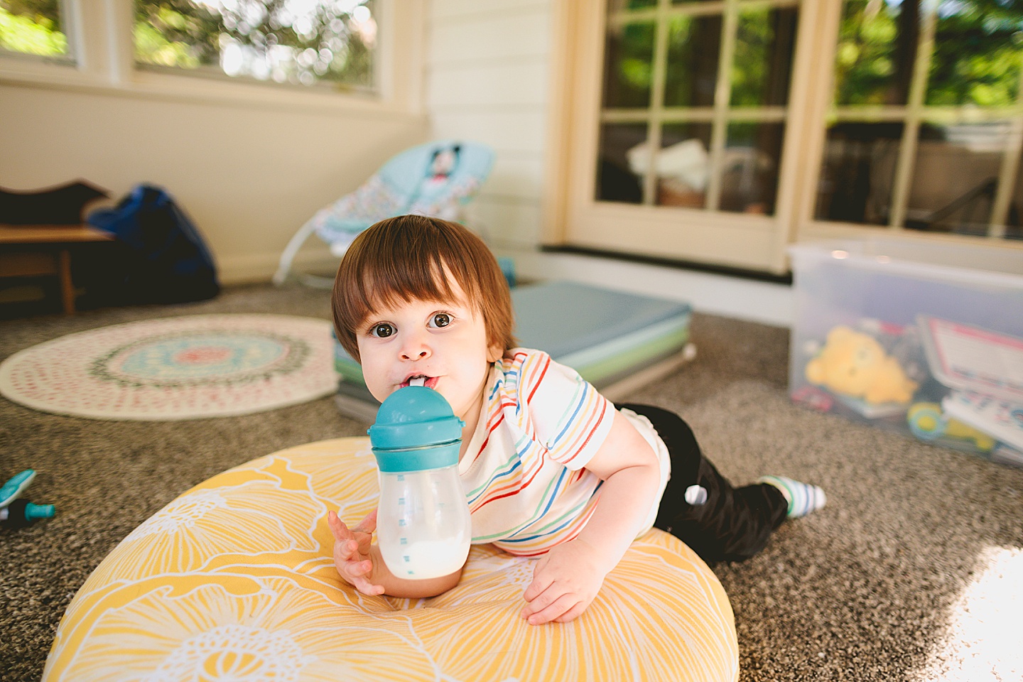 Toddler drinking milk on the floor