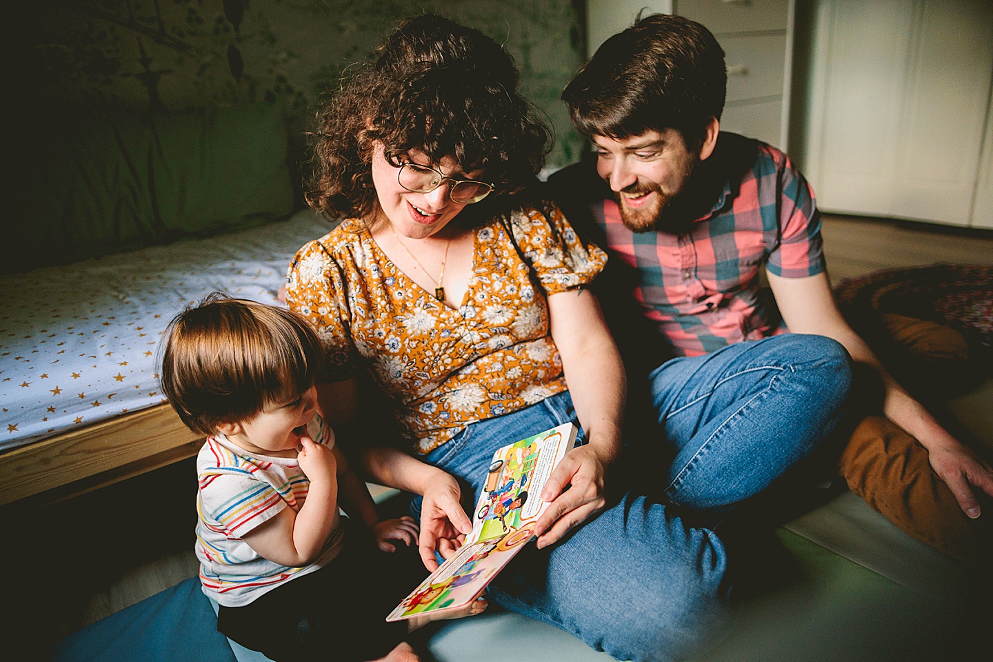 Mom reads book to son on the floor