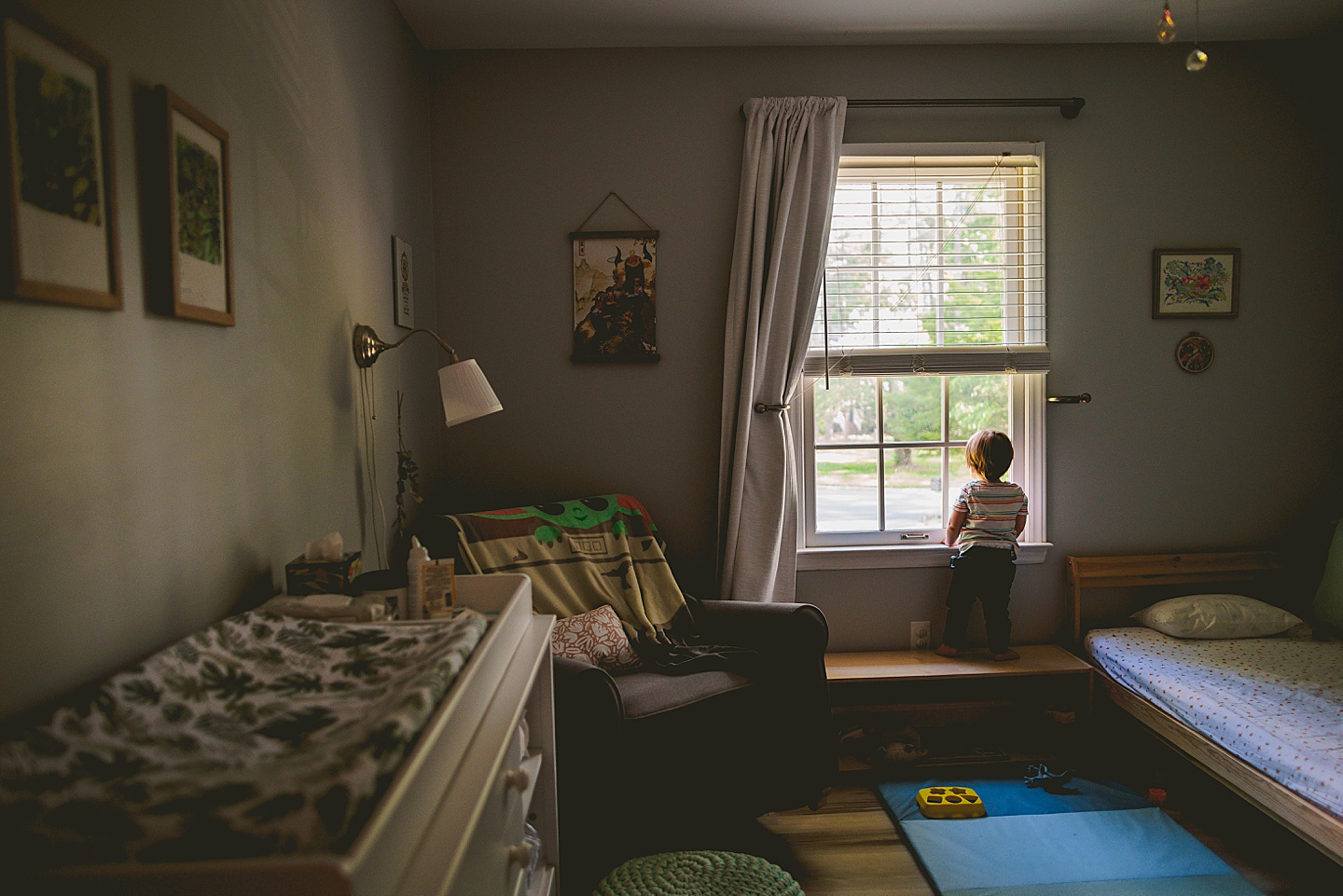 Little kid looks out window