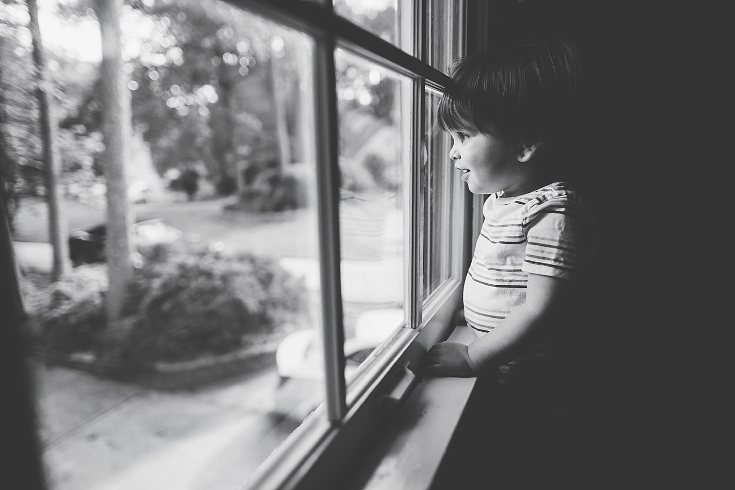 Little kid looks out window