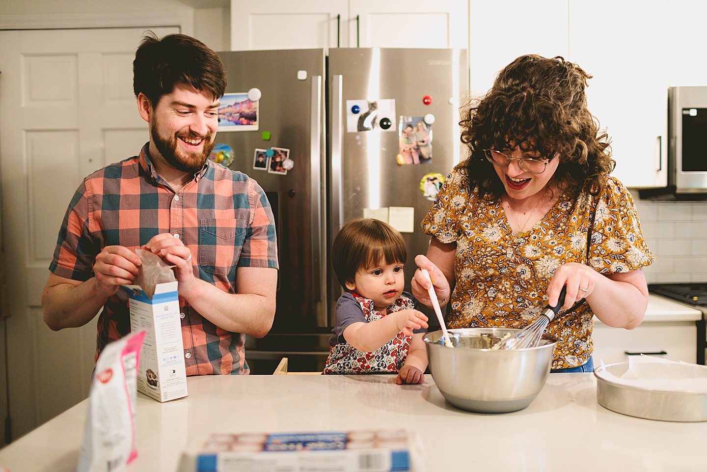 Toddler helps make brownies with parents