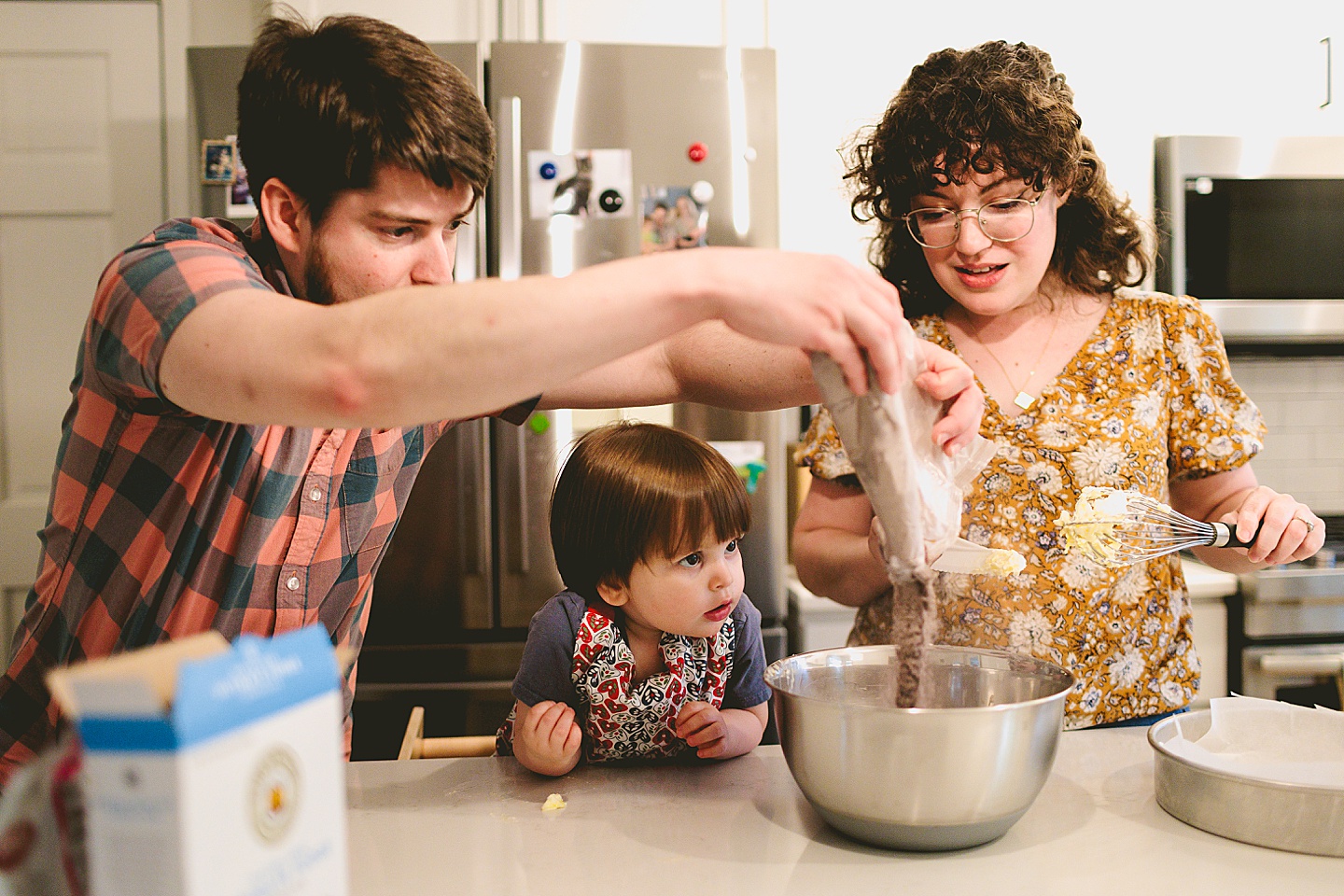 Toddler helps make brownies with parents