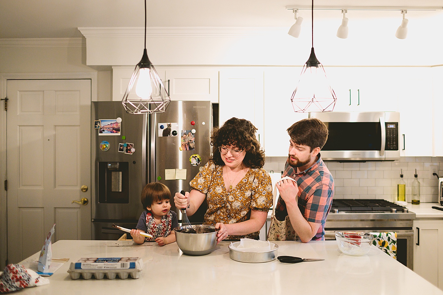 Toddler helps make brownies with parents