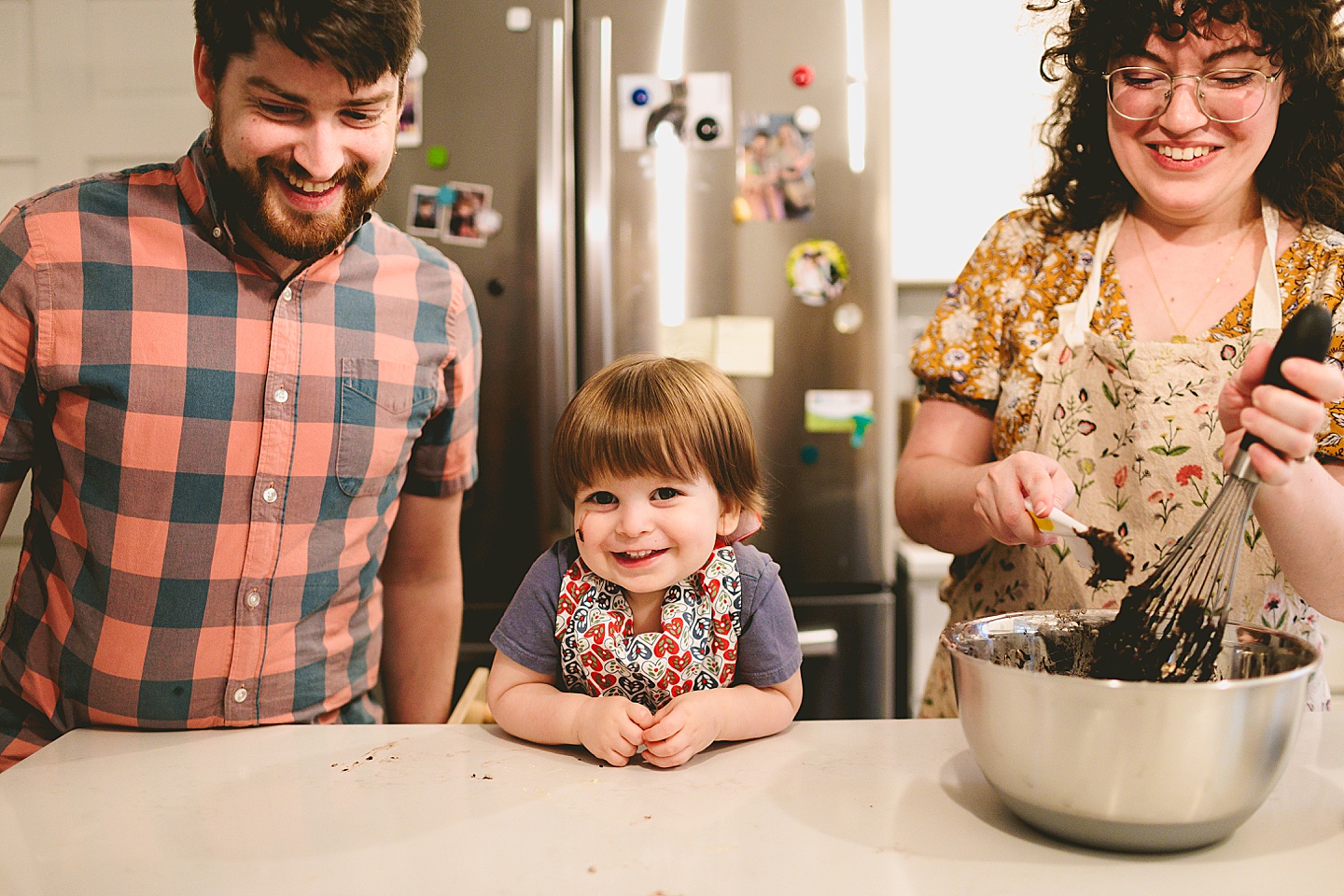 Toddler helps make brownies with parents