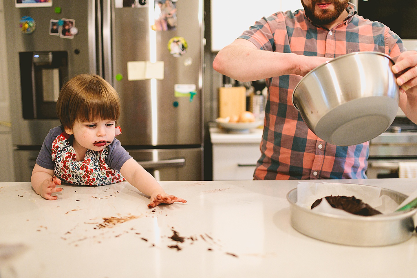 Toddler helps make brownies with parents