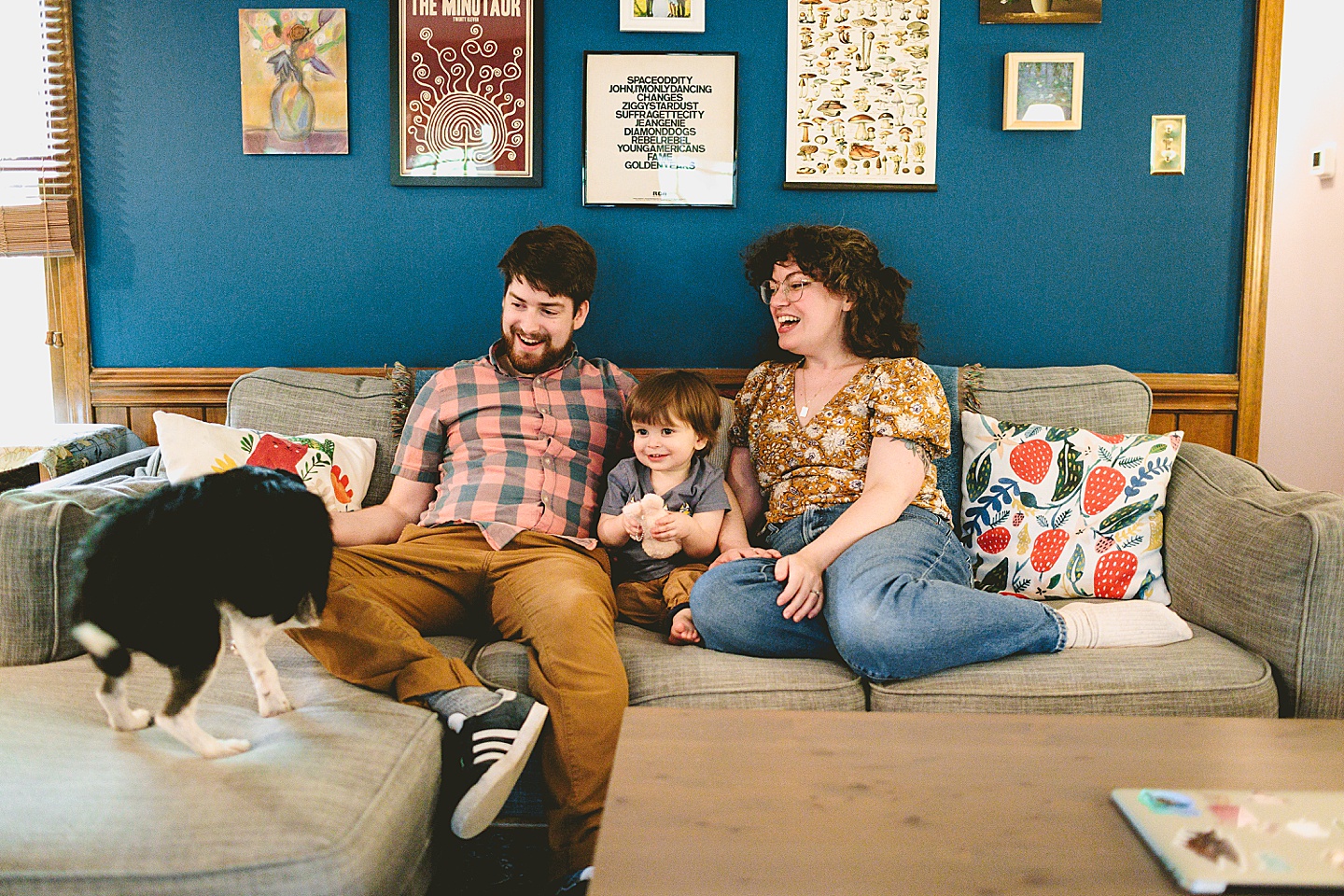 Kid sits on couch with his parents