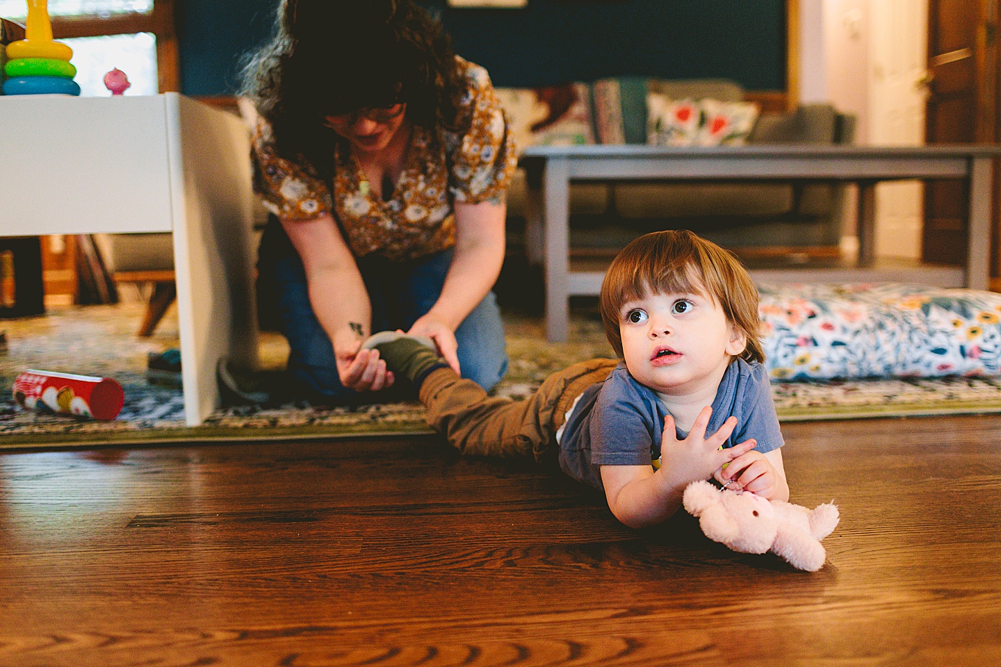 Mom puts shoes on toddler