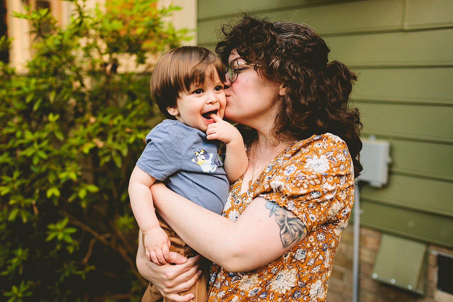 Mom kisses toddler on the cheek