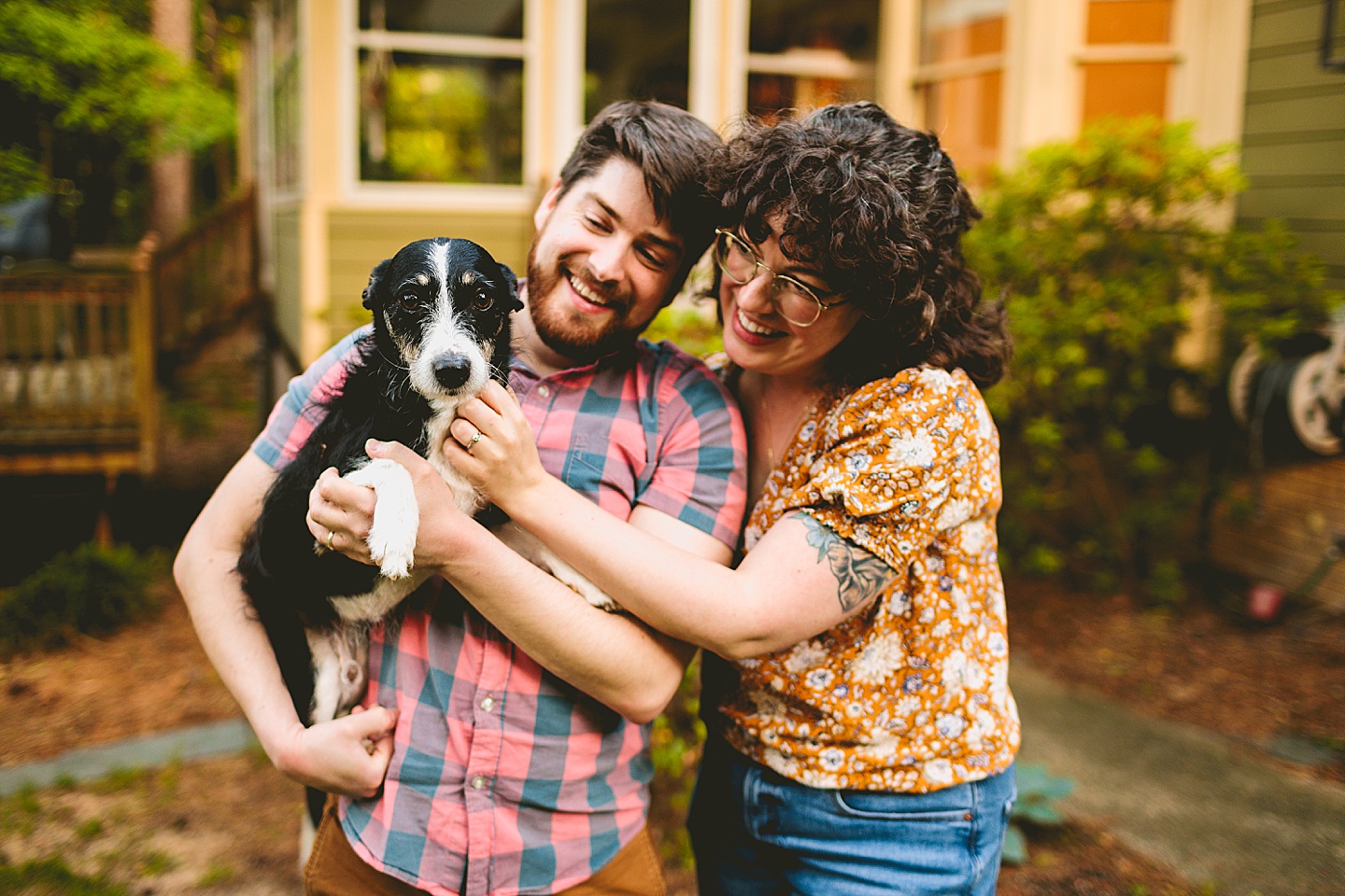 Couple holding their dog during pictures