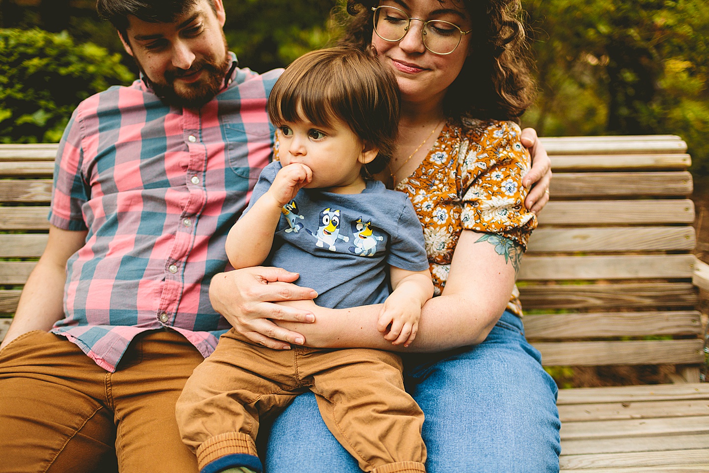 Couple holding baby on swing