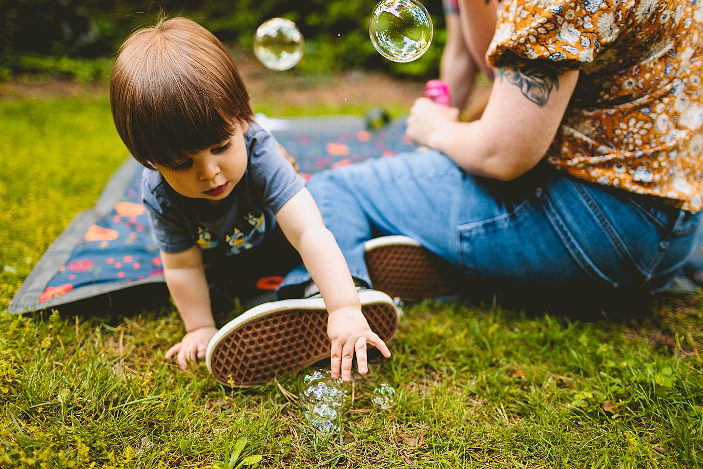 Parents playing with bubbles and kid