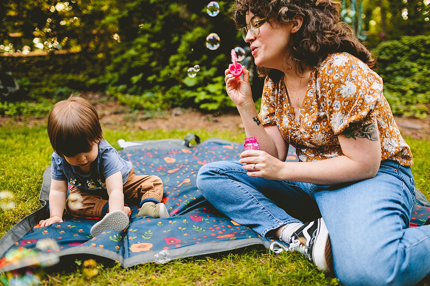 Parents playing with bubbles and kid