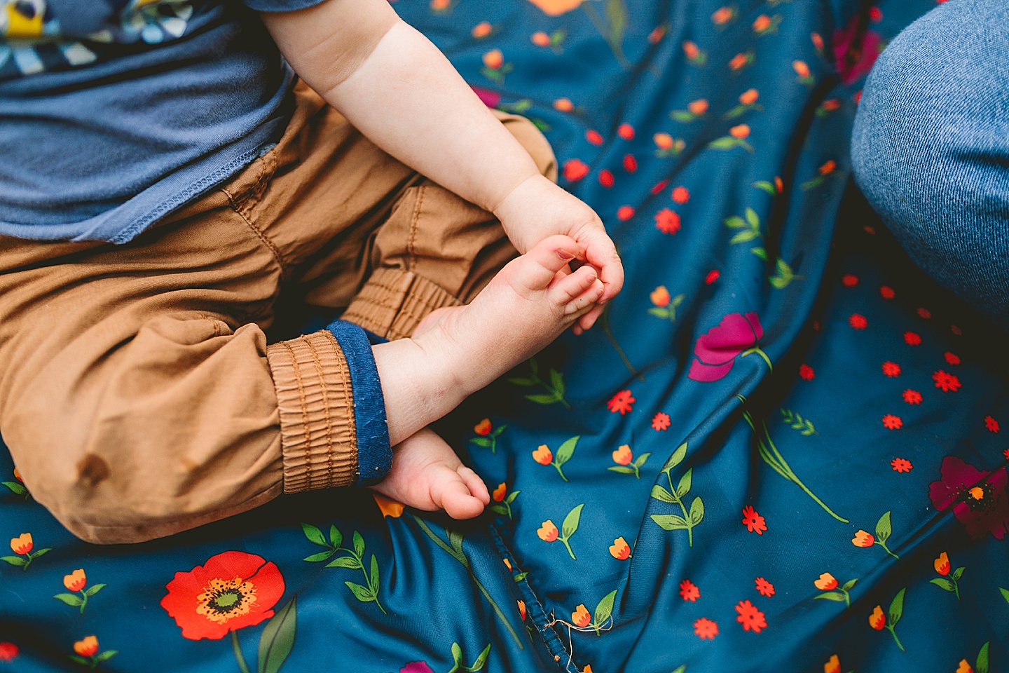 Toddler holding his feet