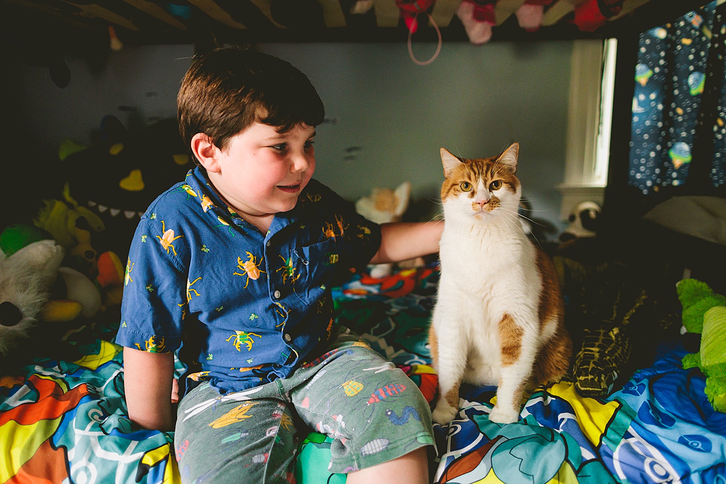 Boy sitting next to his cat