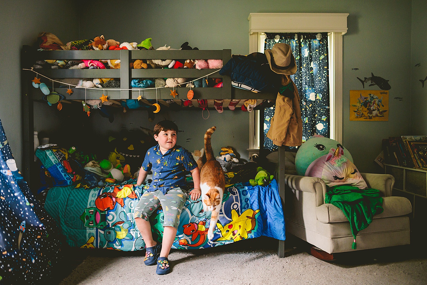 Kid sitting on his bed with his cat